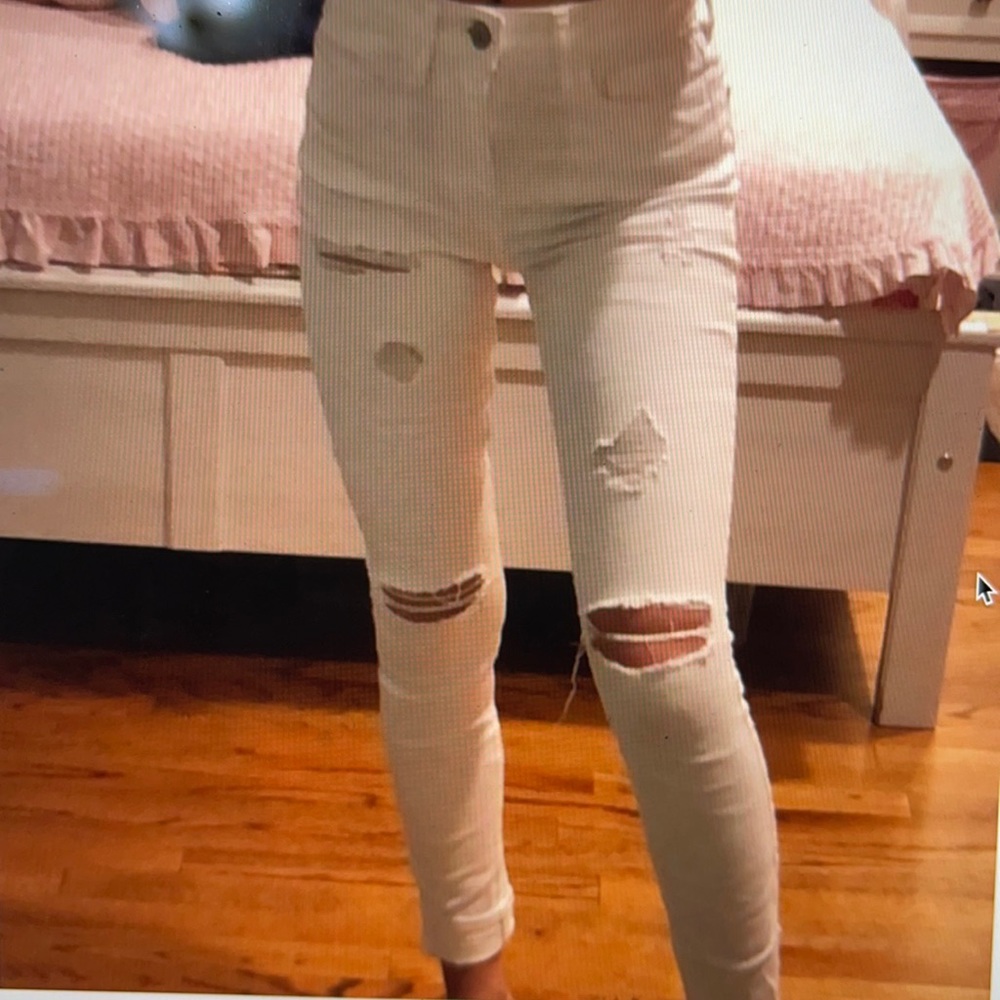 White ripped jeans. Size 9R. Only worn a few times small stain on the calf.